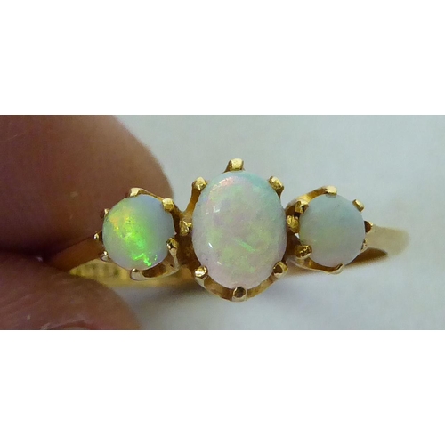 298 - An 18ct gold three stone opal ring