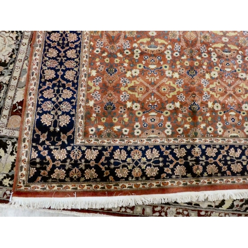 30 - A Persian rug, decorated with small flower head designs and a border, on a multi-coloured ground&nbs... 