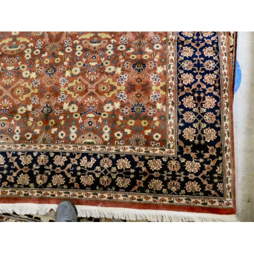 30 - A Persian rug, decorated with small flower head designs and a border, on a multi-coloured ground&nbs... 