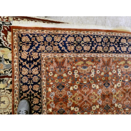 30 - A Persian rug, decorated with small flower head designs and a border, on a multi-coloured ground&nbs... 