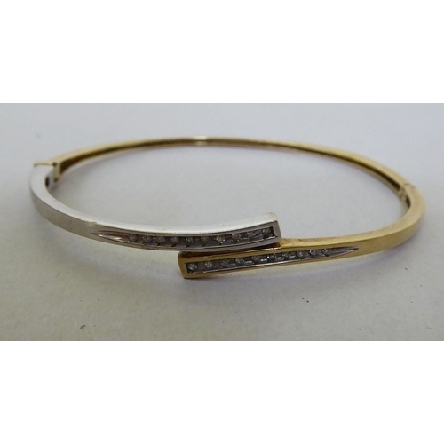 300 - A 9ct gold diamond set bangle