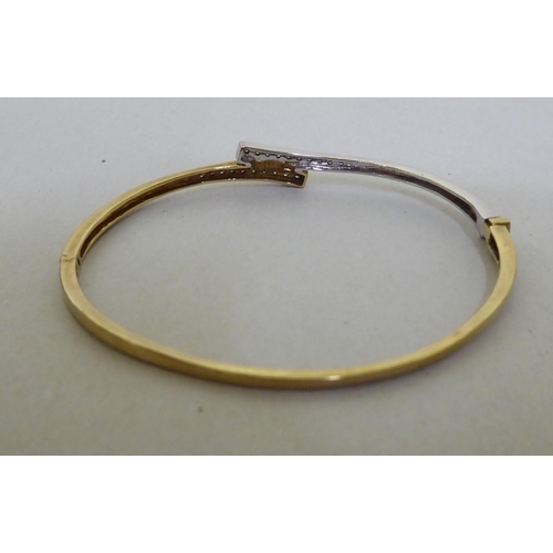 300 - A 9ct gold diamond set bangle