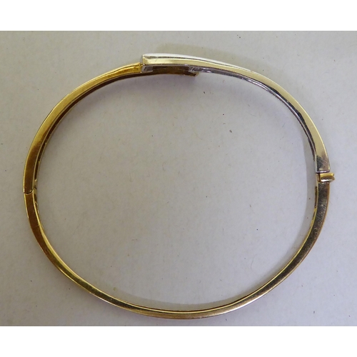 300 - A 9ct gold diamond set bangle