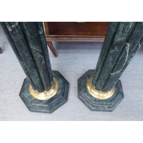 302 - A pair of modern 19thC Italian style, mottled green marble and gilt metal, reeded capital pedestals,... 