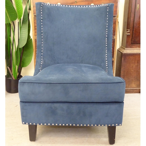 303 - A modern stud upholstered, blue fabric bedroom chair, raised on square, tapered legs