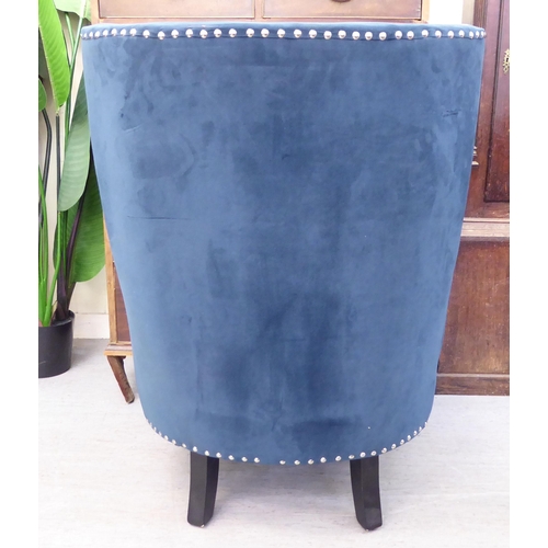 303 - A modern stud upholstered, blue fabric bedroom chair, raised on square, tapered legs