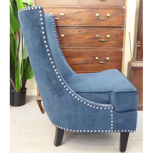 303 - A modern stud upholstered, blue fabric bedroom chair, raised on square, tapered legs