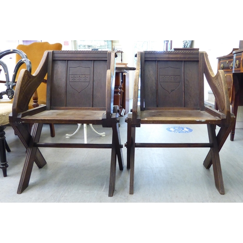 304 - A pair of 20thC oak Glastonbury style chairs