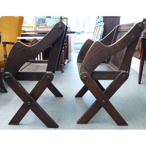 304 - A pair of 20thC oak Glastonbury style chairs