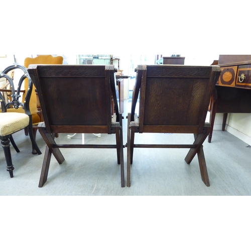 304 - A pair of 20thC oak Glastonbury style chairs