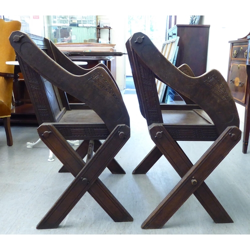 304 - A pair of 20thC oak Glastonbury style chairs