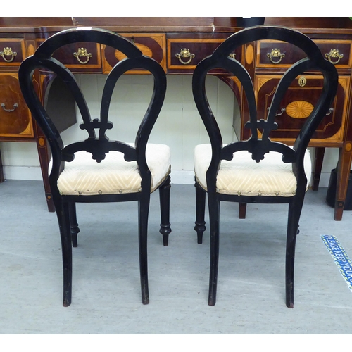 305 - A pair of late Victorian, ebonised framed and gilt, button effect chairs with later fabric upholster... 