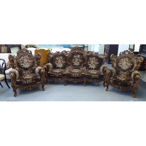 307 - A modern elaborate Italian influenced, carved and stained beech three piece suite  comprising a... 