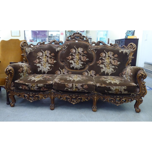 307 - A modern elaborate Italian influenced, carved and stained beech three piece suite  comprising a... 