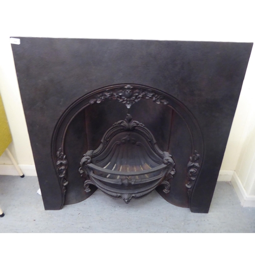 308 - A 20thC cast iron, one piece fire surround and basket  40