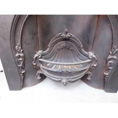 308 - A 20thC cast iron, one piece fire surround and basket  40