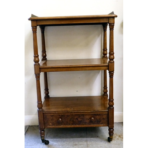 319 - An early 20thC walnut and mahogany three tier, single drawer what-not, raised on turned, pillar supp... 