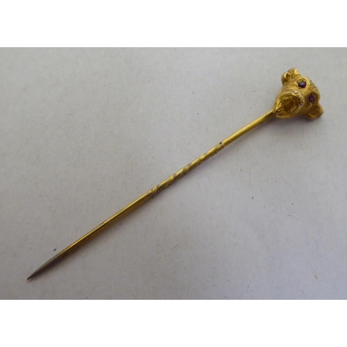 326 - A 9ct gold pin brooch, the finial fashioned as a bull's head, set with ruby eyes