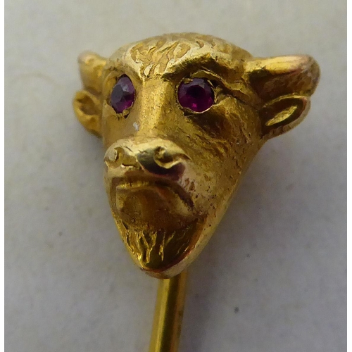 326 - A 9ct gold pin brooch, the finial fashioned as a bull's head, set with ruby eyes