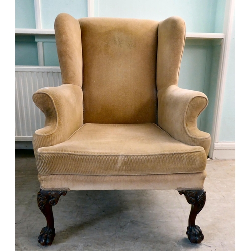 33 - A 1930s Georgian inspired, fabric upholstered, enclosed wingback armchair, raised on C-scroll and fo... 