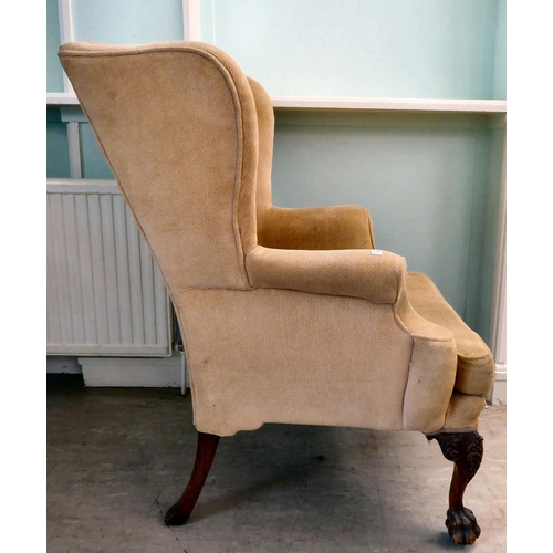 33 - A 1930s Georgian inspired, fabric upholstered, enclosed wingback armchair, raised on C-scroll and fo... 