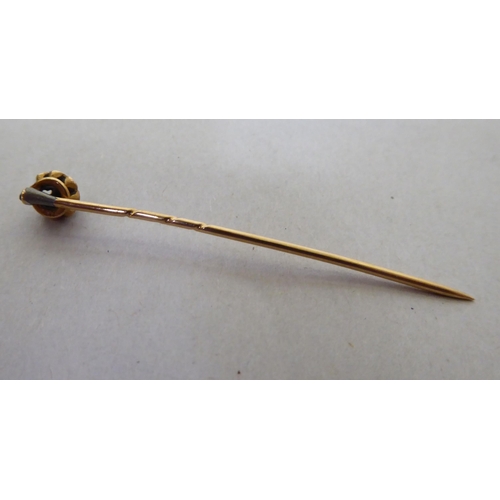 331 - A yellow metal scarf pin, set with a diamond