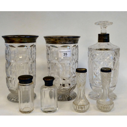 35 - A mixed lot: to include a pair of lead crystal vases, each with a silver collar  London 1922  7.5