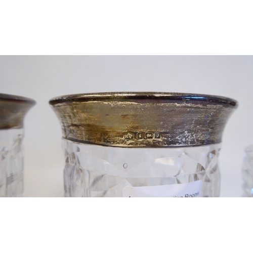 35 - A mixed lot: to include a pair of lead crystal vases, each with a silver collar  London 1922  7.5