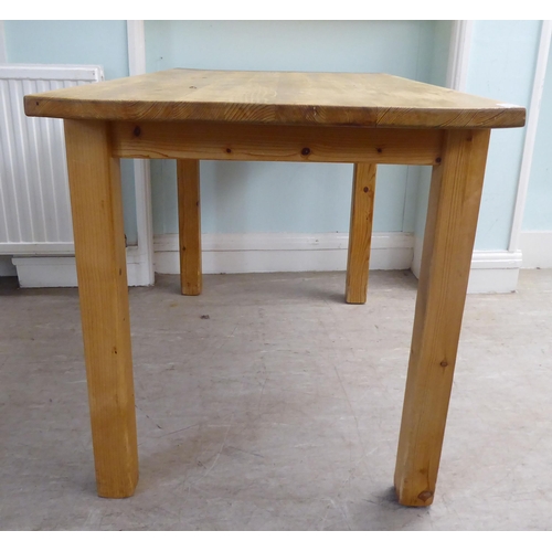 38 - A 20thC pine table, raised on square legs  29