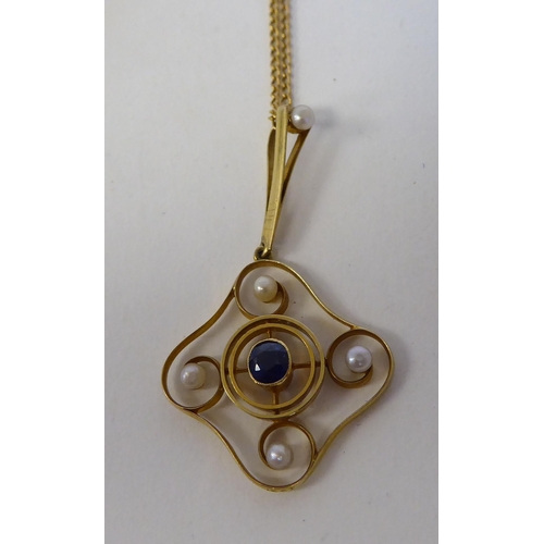 45 - A late Victorian 15ct gold pendant, set with seed pearls and a sapphire, on a 9ct gold chain; and an... 