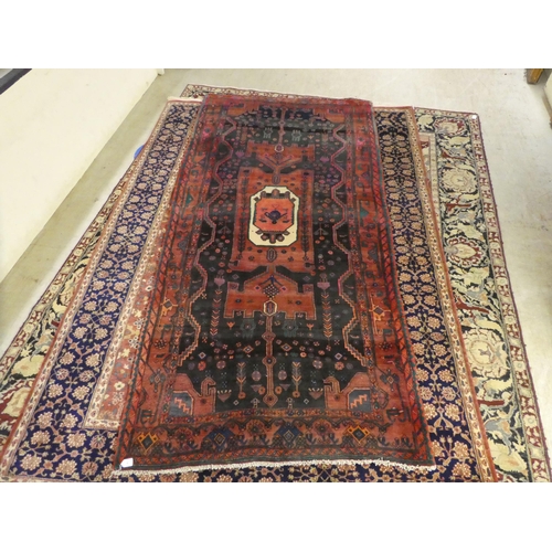 5 - A Persian runner, decorated with a central medallion and floral designs, on a green and red ground  ... 