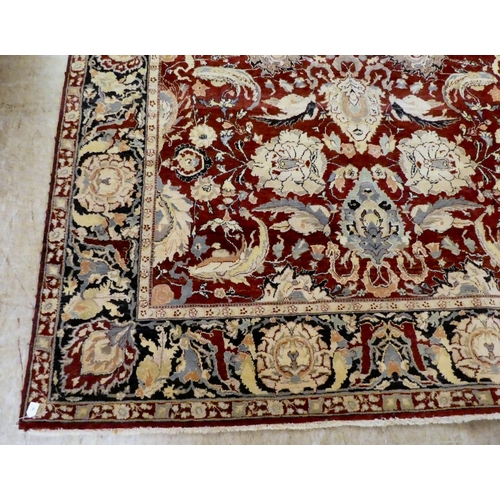 56 - A Persian rug, decorated with stylised flora and foliage designs, on a multi-coloured ground  98