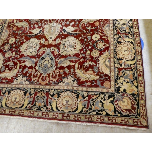 56 - A Persian rug, decorated with stylised flora and foliage designs, on a multi-coloured ground  98