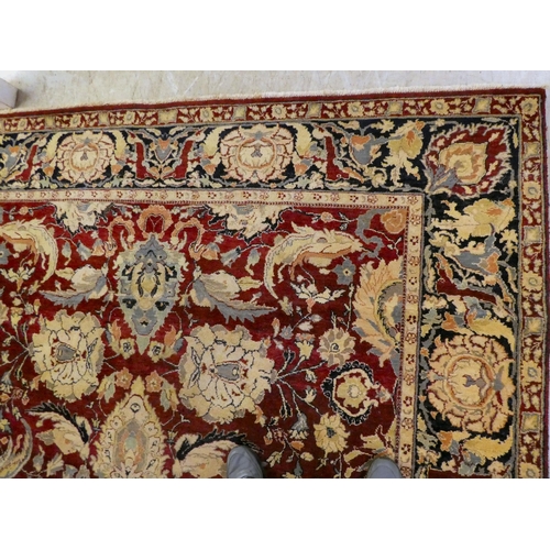 56 - A Persian rug, decorated with stylised flora and foliage designs, on a multi-coloured ground  98