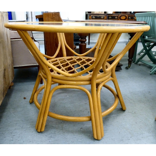 58 - A modern lacquered bentwood conservatory table with a glass inset top, raised on splayed legs  ... 