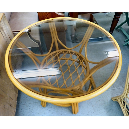 58 - A modern lacquered bentwood conservatory table with a glass inset top, raised on splayed legs  ... 