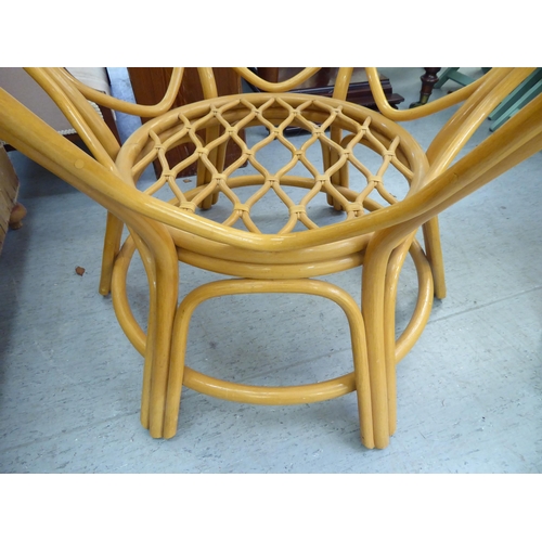 58 - A modern lacquered bentwood conservatory table with a glass inset top, raised on splayed legs  ... 