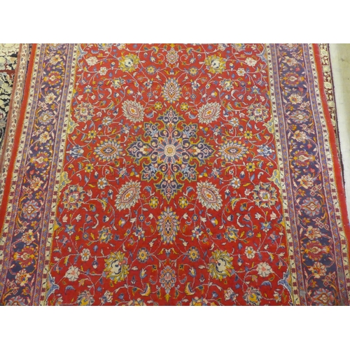 60 - A Central Persian rug, decorated with floral designs, on a mainly red ground  90