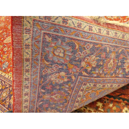 60 - A Central Persian rug, decorated with floral designs, on a mainly red ground  90