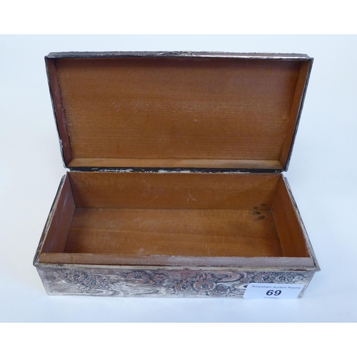 69 - A silver plated jewellery box, decorated in relief with flowers and birds  7.25