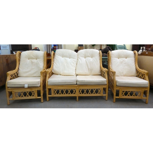 8 - A caned and bamboo conservatory suite  comprising a two person settee, a pair of armchairs and a cof... 