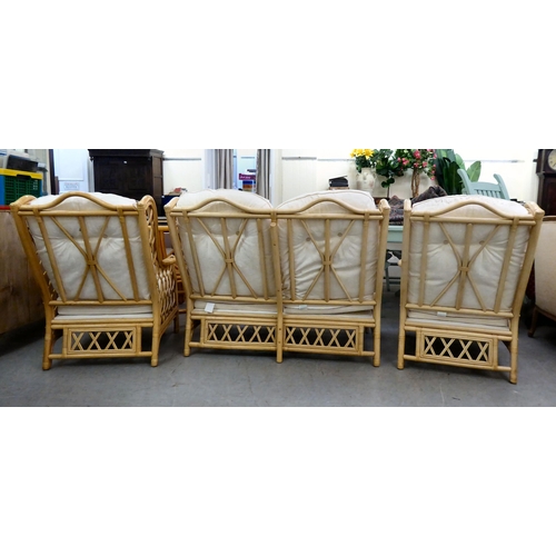 8 - A caned and bamboo conservatory suite  comprising a two person settee, a pair of armchairs and a cof... 