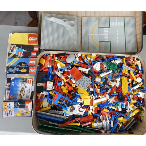 81 - A suitcase of Lego components; and circa 1980s Lego ephemera