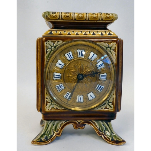 89 - An early 20thC Continental foliate moulded china, square cased mantel timepiece; faced by a brass an... 