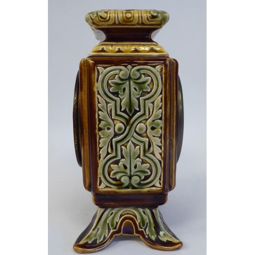 89 - An early 20thC Continental foliate moulded china, square cased mantel timepiece; faced by a brass an... 