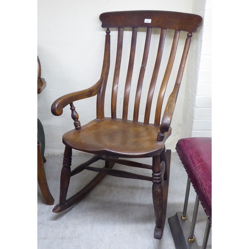 227 - A late Victorian country made, beech and oak, high lath back, open arm chair, the solid seat raised ... 