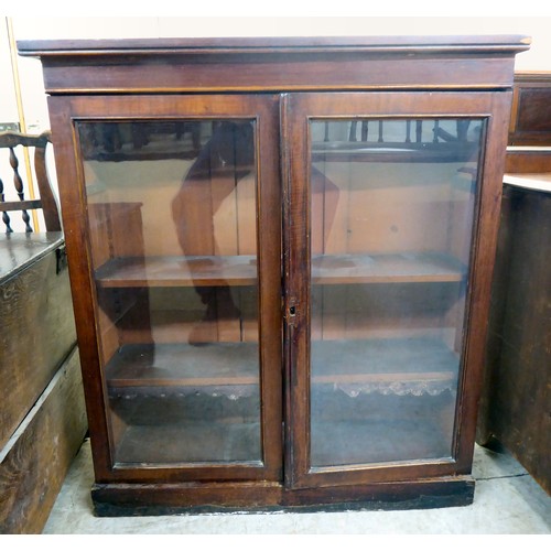 247 - A late Victorian mahogany cupboard, the shelved interior enclosed by a pair of glazed, panelled door... 