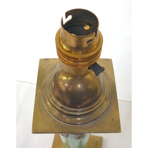 44 - An early 20thC brass table lamp incorporating an opaque, pale green glass column, on a stepped, squa... 