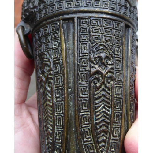 148 - A Chinese cast bronze vase of shouldered, tapered form with a narrow neck and flared rim, decorated ... 