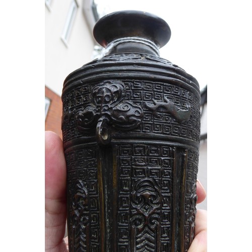 148 - A Chinese cast bronze vase of shouldered, tapered form with a narrow neck and flared rim, decorated ... 